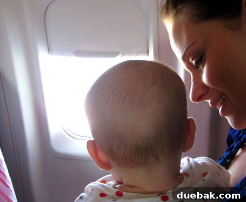 Baby Clara looking out the airplane window