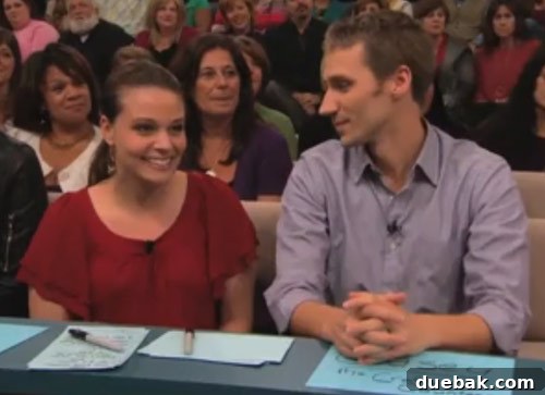 Couple sitting at a judge's desk on The Nate Berkus Show set