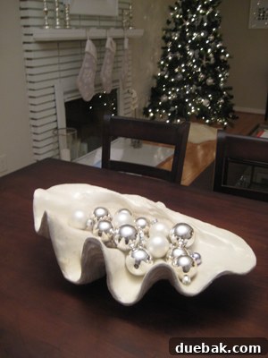 The Festive Evergreen 3 Close-up of silver Christmas ornaments reflecting light, creating a sparkling and festive detail in a home's holiday decor.