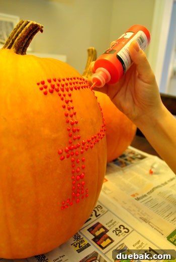 Create Whimsical Puffy Paint Pumpkins 7 Puffy paint being applied to a pumpkin