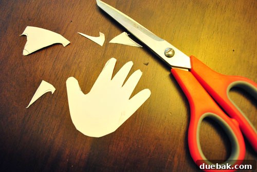 Tracing the handprint template onto the pumpkin