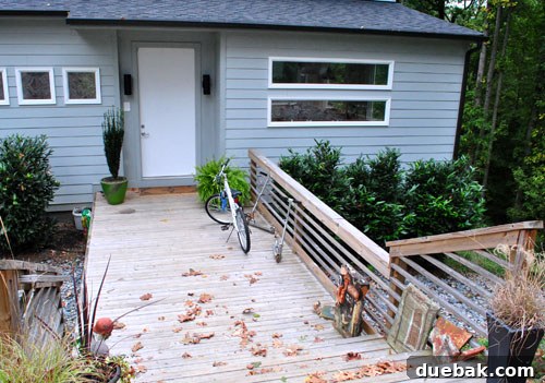 Emily's entryway before the makeover, featuring a plain door and deck