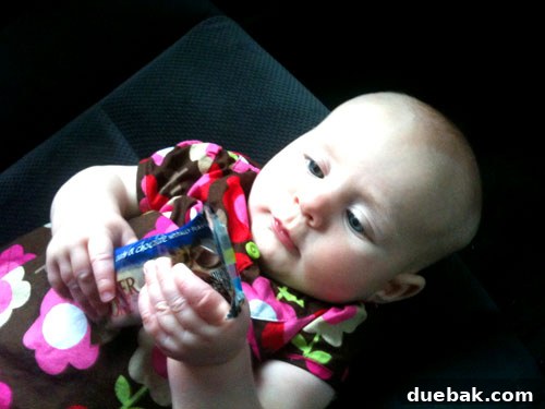 Mastering House Showings For Sale By Owner 4 A baby joyfully playing with a granola bar wrapper, highlighting simple pleasures