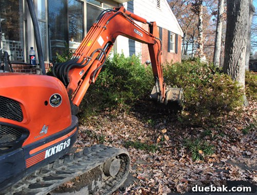 Excavator digging up an underground oil tank at a residential property