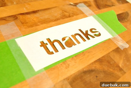 Homemade paper stencil cut out onto painters tape