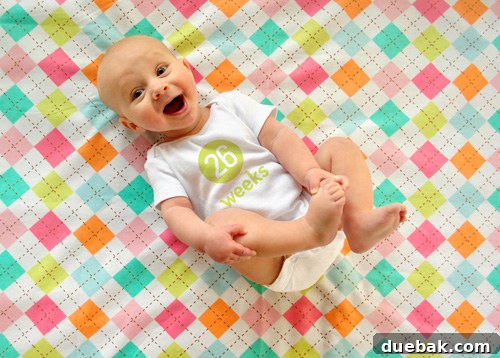 Clara at six months, smiling and joyful during her weekly baby photo shoot