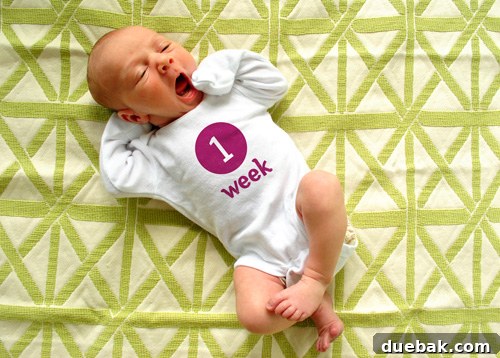 Baby Clara mid-yawn during her weekly photo session, capturing a sweet sleepy moment