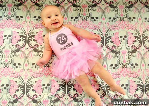 Baby Clara dressed in a ballerina costume for Halloween, complete with pointed toes, for her weekly photo