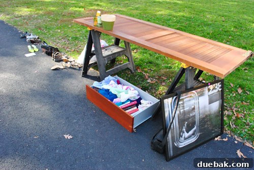 Nearly empty driveway after a successful moving sale, showing very few remaining items.