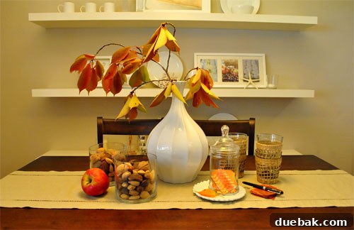 Harvest Home: Autumn Decor Inspiration 2 Dining table decorated with vibrant cherry tree branches as a fall centerpiece