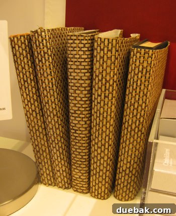 DIY inspiration: Books covered with elegant grasscloth wallpaper, offering texture and sophistication.