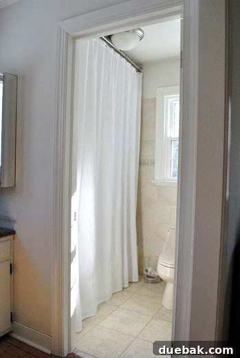 After: A beautifully installed high-hung shower curtain, creating an illusion of height and elegance