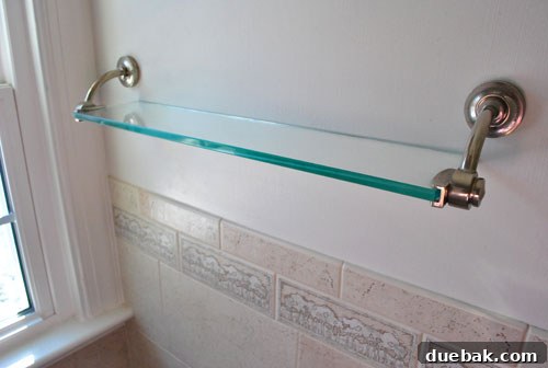 Elegant spa-like glass shelves providing practical storage in the shower area