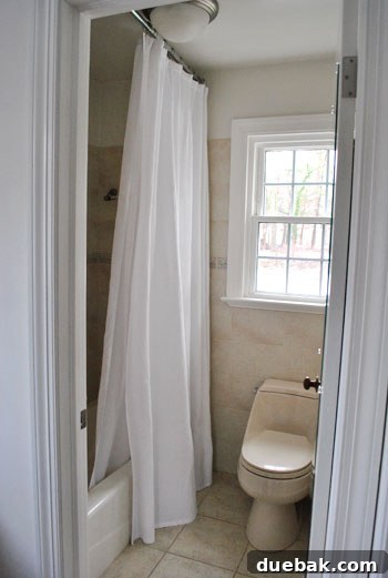 Spacious master bathroom with clean fixtures and ample light