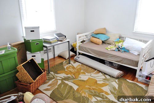 Cluttered playroom, clearly not yet designed for children, full of boxes