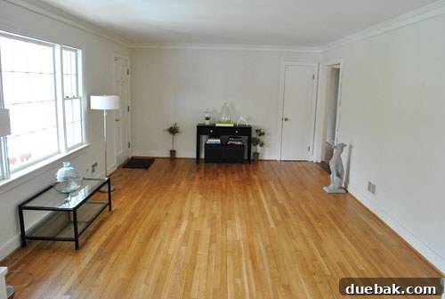 Close-up of organized built-in shelves in living room, showcasing temporary arrangements