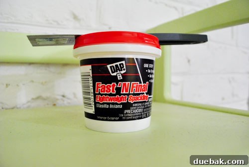 Container of lightweight spackle used for wall repair, emphasizing ease of use