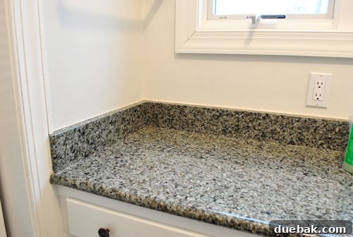 Removing Our Bathroom Sink's Side and Backsplash 2 Before shot of a bathroom sink with a granite backsplash in a bedroom nook