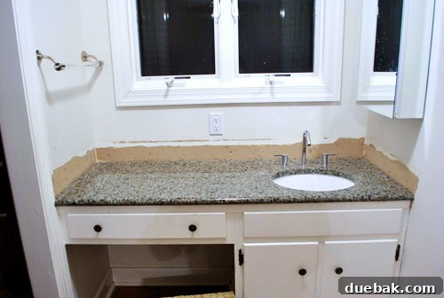 Removing Our Bathroom Sink's Side and Backsplash 9 Wall behind the sink after initial cleanup, before skim coating