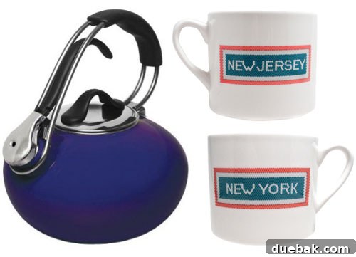 Chantal Loop tea kettle in cobalt blue next to two 'Tunnel Vision' mugs from Fishs Eddy, perfect for tea lovers