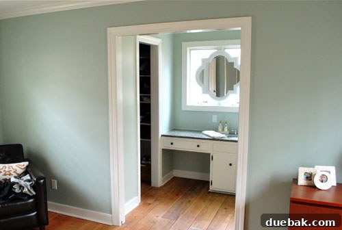 The newly painted white mirror frame, showcasing its seamless integration with the surrounding bathroom trim