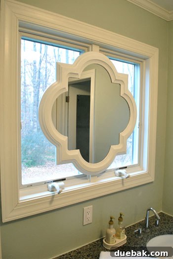 A close-up of the freshly painted white mirror frame, highlighting the semi-gloss finish and smooth texture