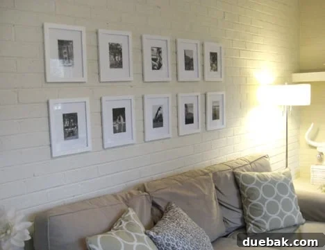 Elegant black and white photo frames arranged in a modern grid gallery wall, DIY home decor project