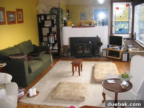 Before photo of an old, unpainted concrete fireplace mantle and a large, frameless mirror