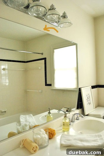 The Secret Our House Kept: A Message From The Shadows 2 Hidden note peeking from behind a bathroom mirror, highlighted by an orange arrow.