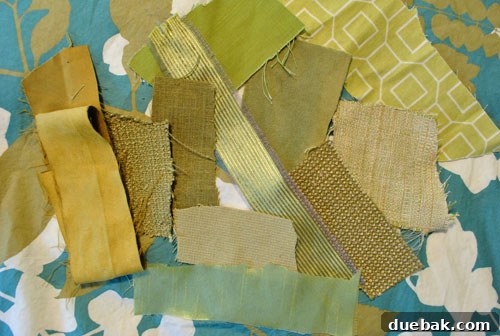 Multiple fabric swatches, mostly green and gold tones, gathered together
