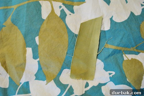A single avocado-green fabric swatch, subtly ribbed