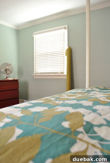 Avocado-green fabric draped over a bed with a green and gold duvet, showing harmonious colors