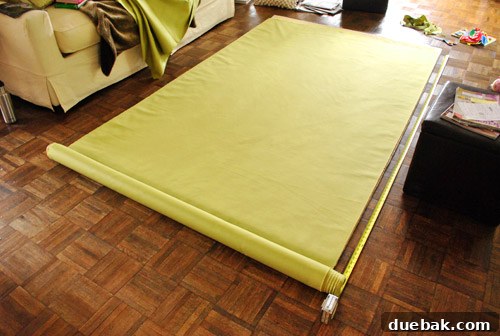 Closeup of yellowy-green fabric remnant after cutting custom curtain panels