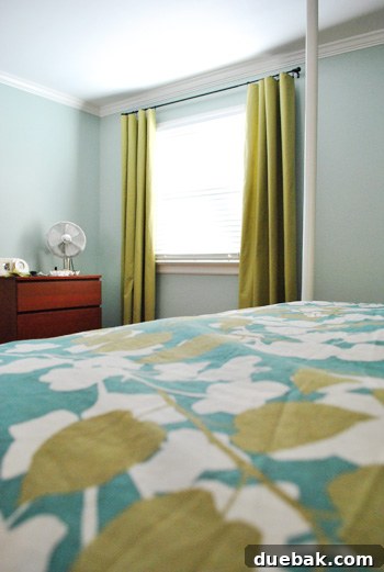 Close-up of the yellow-green curtains complementing bedding and wall color