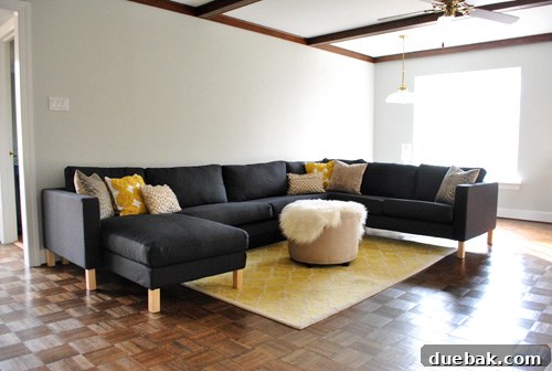 Ikea sectional sofa recently assembled in a modern gray living room, showcasing its ample seating.
