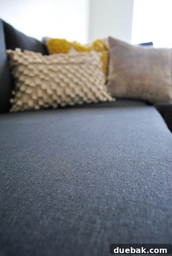Close up detail of Ikea sectional sofa fabric in dark Sivik gray, highlighting its textured and durable weave.