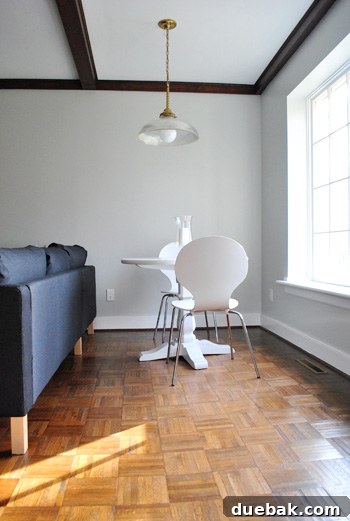 Small seating area in a living room where an Ikea sectional sofa was recently installed, showing an empty space to be redesigned.