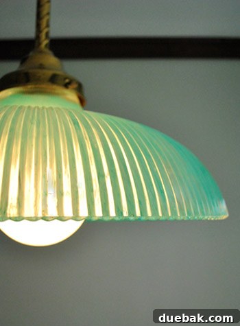 A closer view of the unlit turquoise pendant light, highlighting the soft coloration and handcrafted feel.