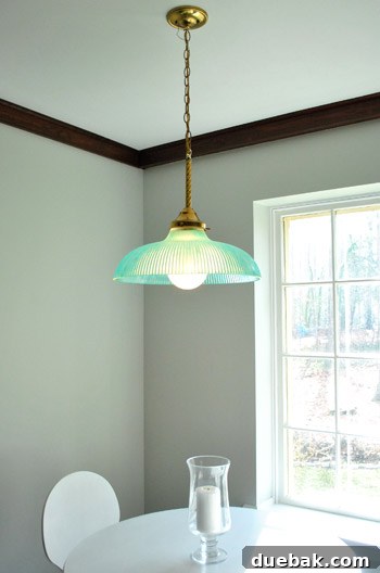 A view looking up at the illuminated turquoise pendant light from below, emphasizing its soft glow and unique charm.