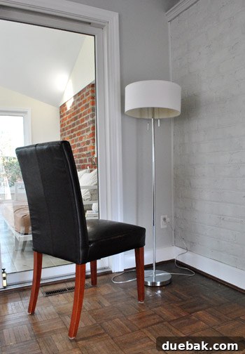Chair positioned to access ceiling for paint swatch testing