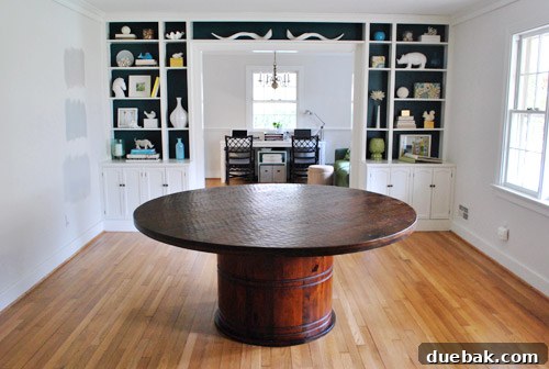 A close-up view of the Stella dining table's elegant dark wood pedestal base.
