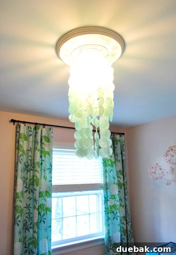 Instant Elegance: Concealing Drywall Cracks with Ceiling Medallions 9 The capiz chandelier illuminated, casting a soft glow and reflections on the newly installed ceiling medallion.
