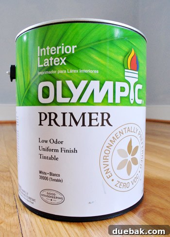Unlock Your Glow: The Best Times to Use Tinted Primer 5 Guest bedroom wall closeup after applying tinted primer, with a paintbrush visible