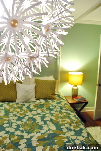Bedroom view showing the Maskros lamp and other elements, including a side table