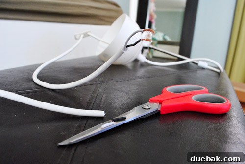 Electrical wires being cut and stripped for the light fixture installation