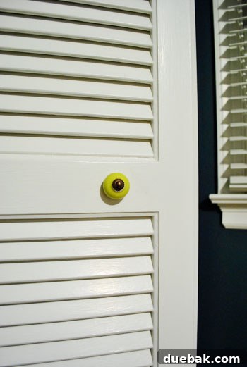 New lime greeny-yellow closet door knob with oil-rubbed bronze hardware in the guest room, adding a pop of color and matching curtain rods.