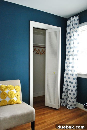 Empty guest room closet with wooden hangers