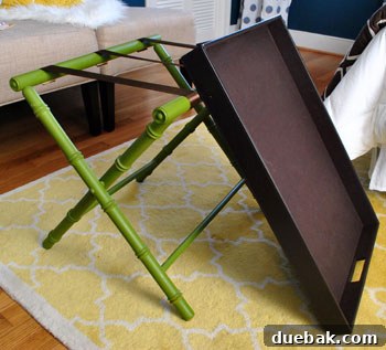 Repairing straps of a green luggage rack with ribbon and staple gun