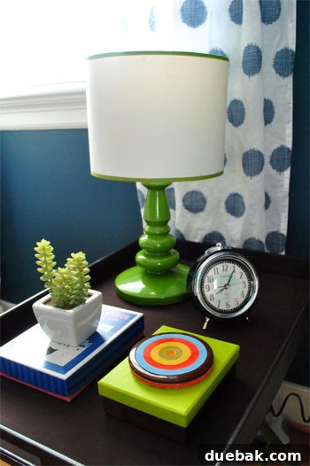 Close-up of DIY nightstand with lamp in renovated guest room
