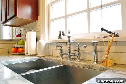 Wide shot of kitchen featuring bulletin board and industrial pendant light